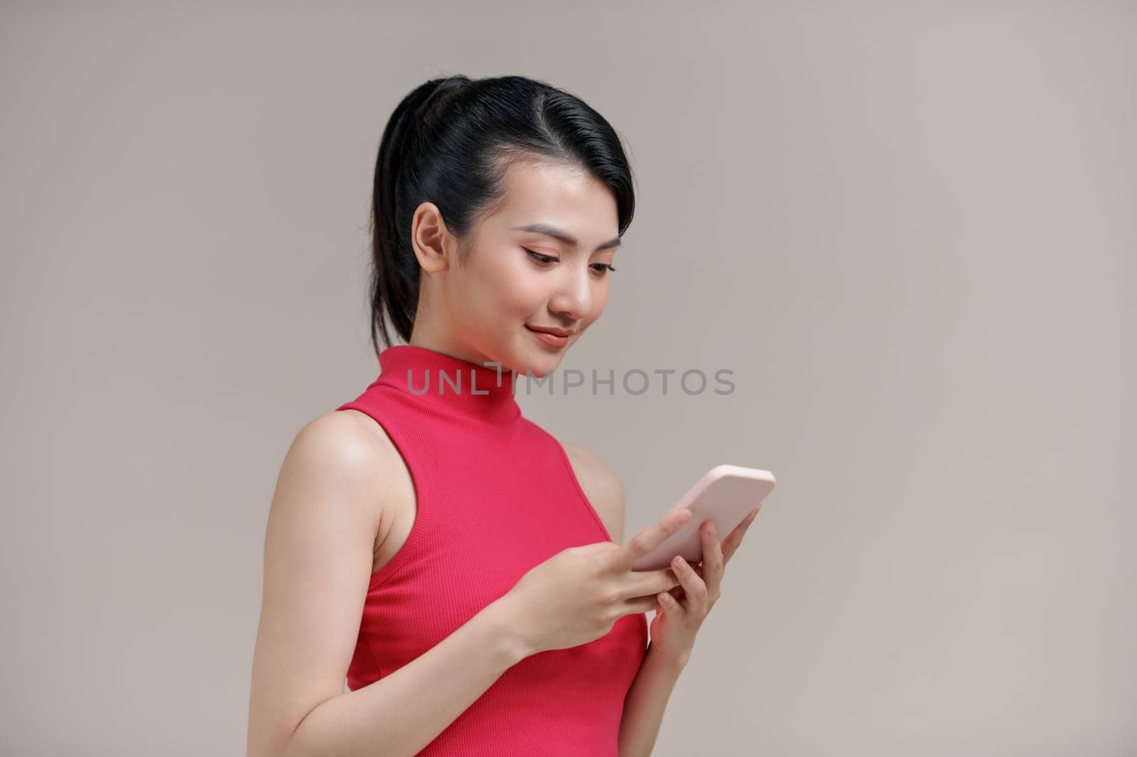 Portrait of a happy asian businesswoman using mobile phone 