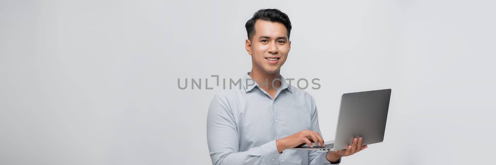 Asian man holding the computer