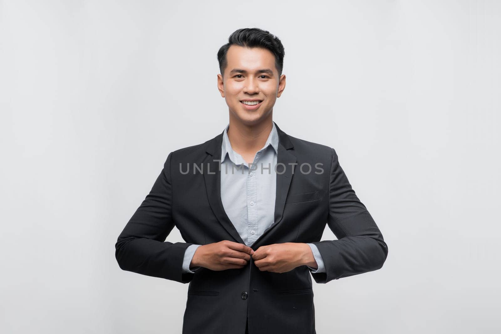 Businessman in suit posing on white background 