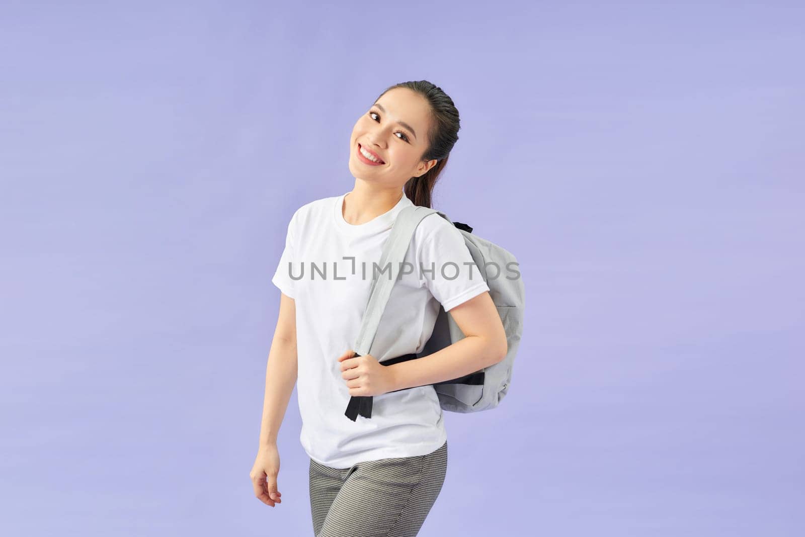 Happy smiling young cute asian student girl with backpack. Beautiful woman tourist.