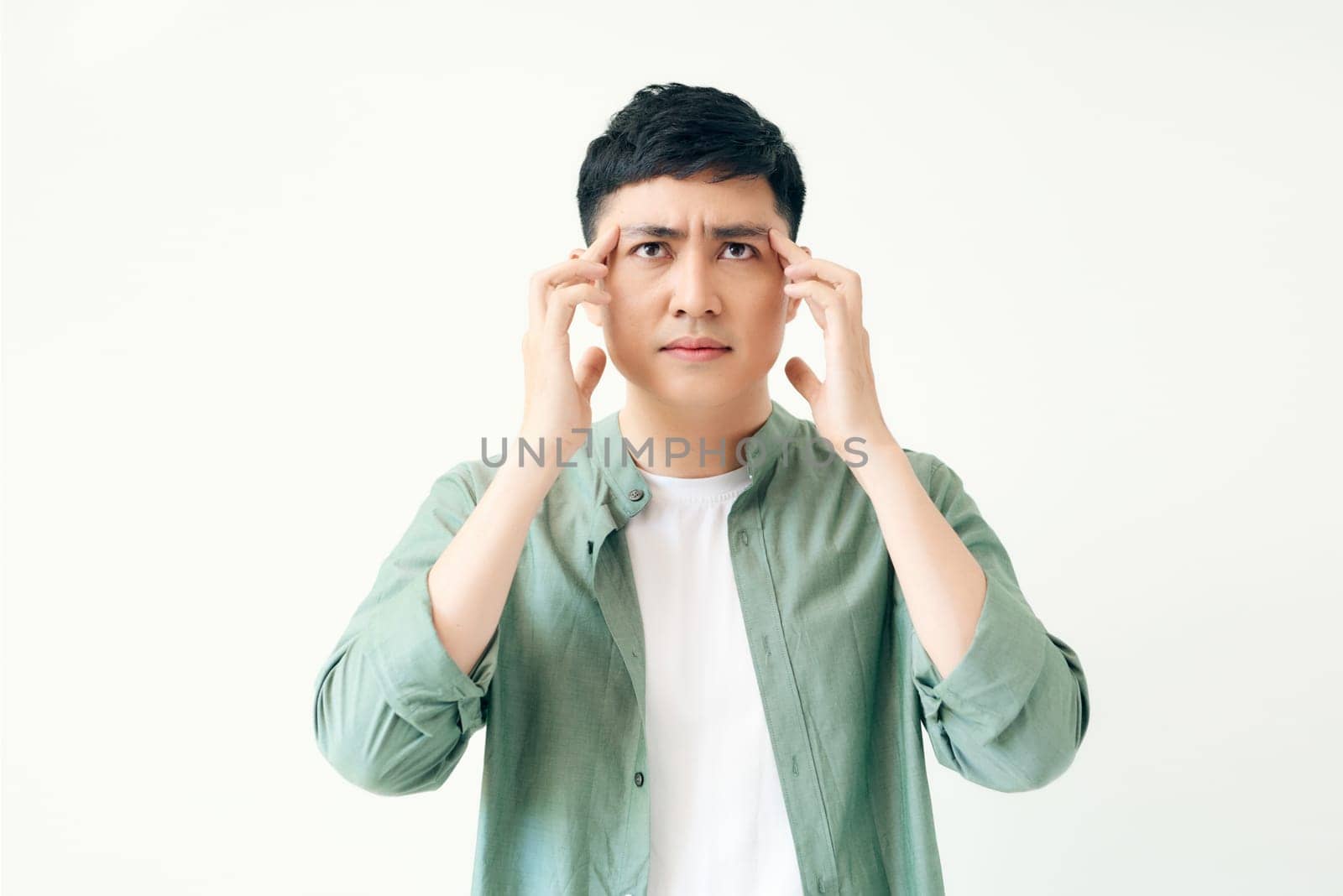 Depressed stressed. Young asian man hand touching headache on isolated white background.