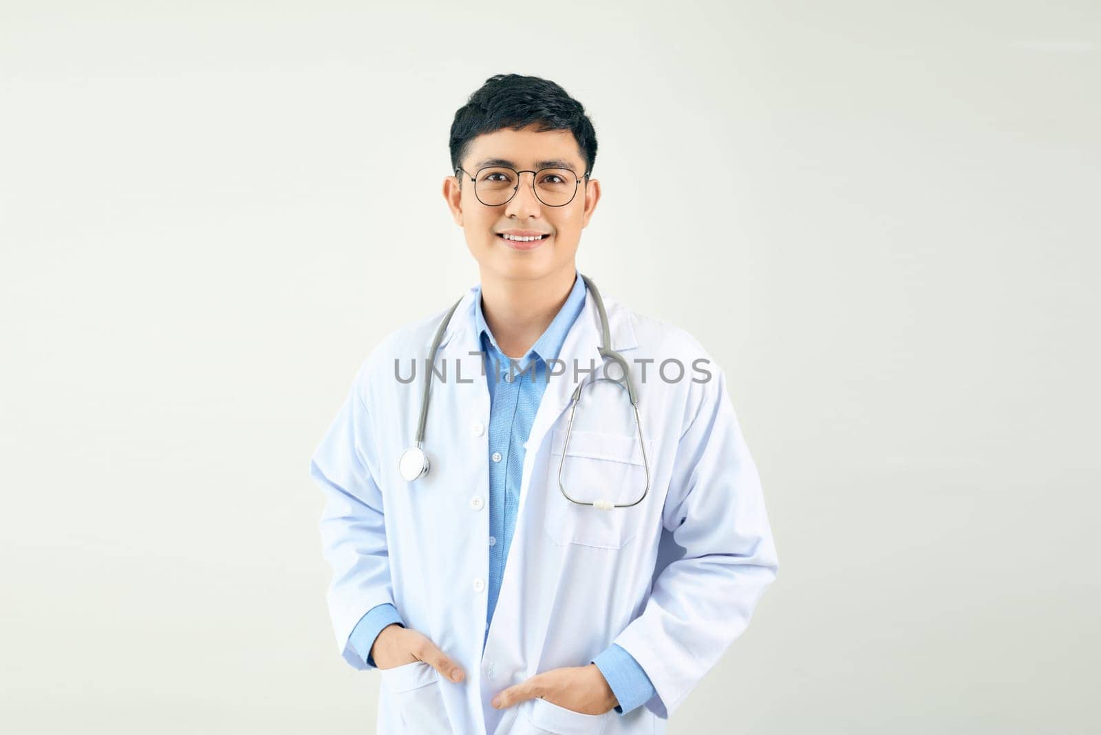 Portrait of male confident doctor over white background studio, healthcare and Medical technology concept.