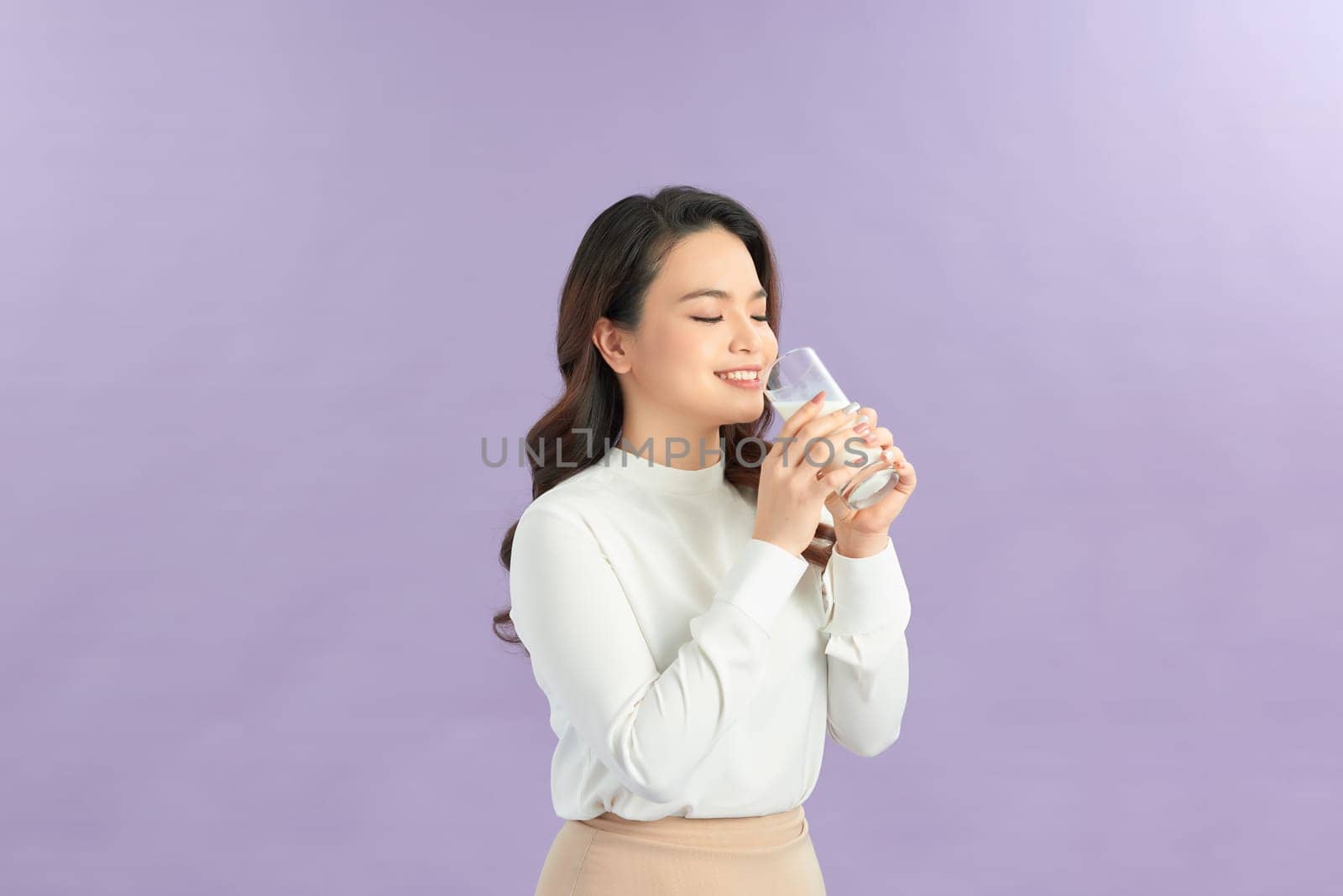 Young smiling happy fun woman wear white clothes hold in hand glass drink 