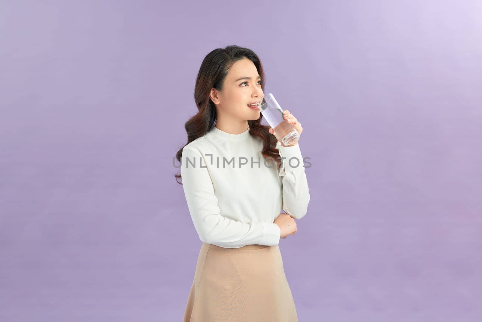 Young woman hold drink clear fresh pure still water from glass 