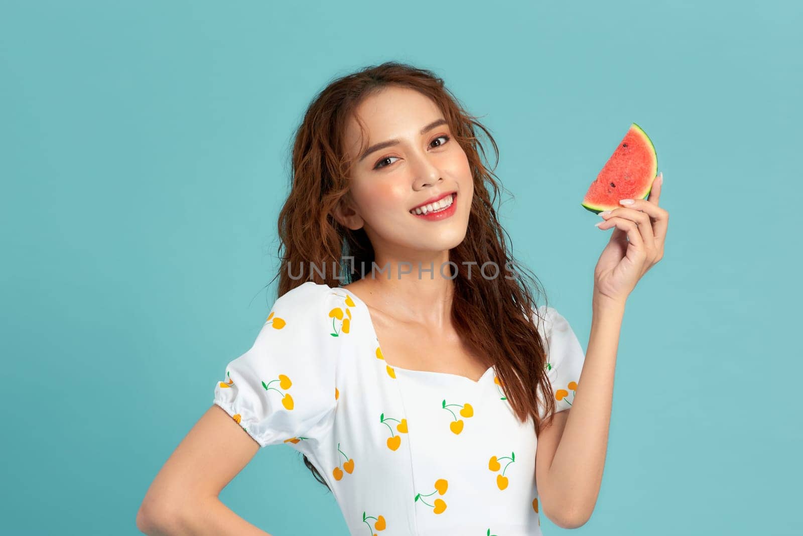 Beautiful young woman with slices of fresh watermelon on color background