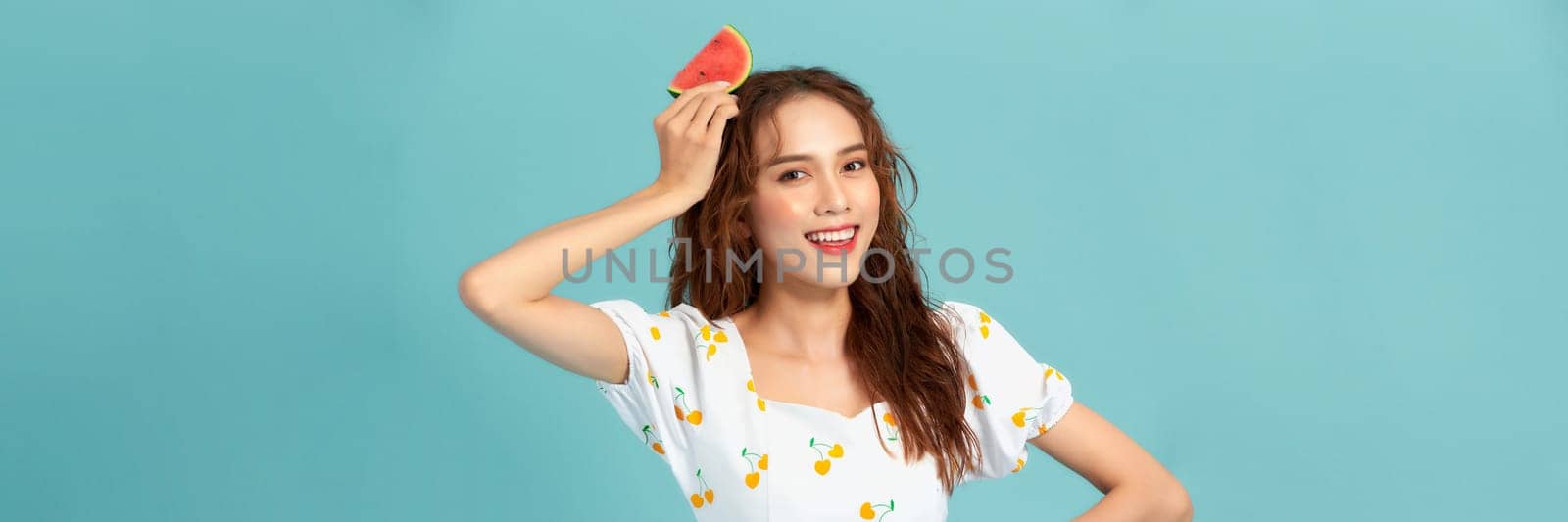 Beautiful young woman with slices of fresh watermelon on color background by makidotvn