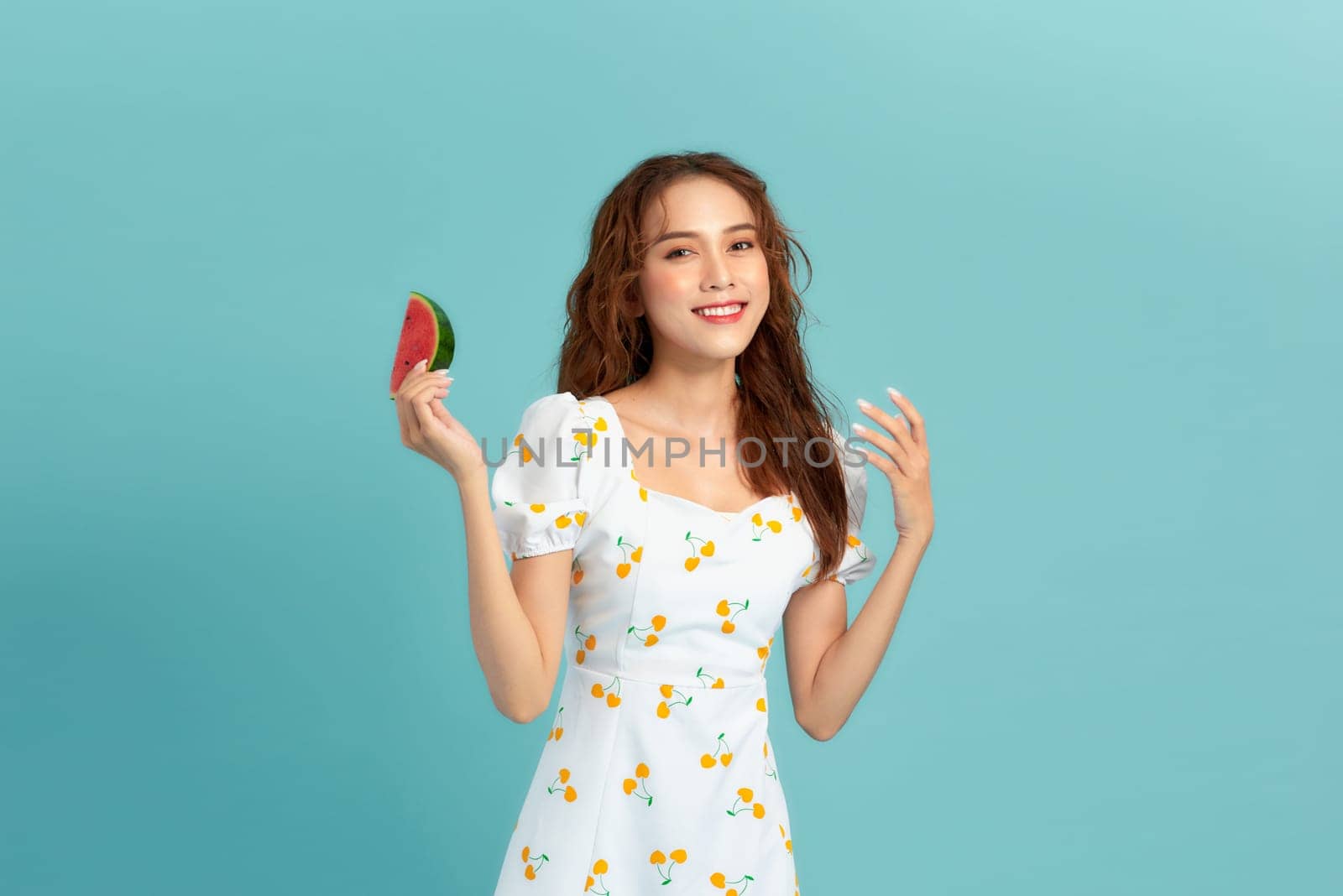 Beautiful happy young woman with fresh watermelon on blue background. Panorama by makidotvn