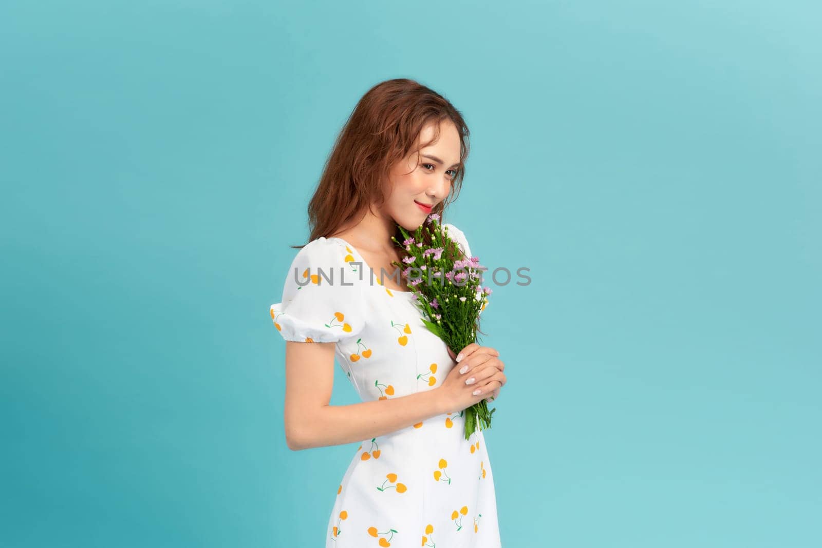 young woman with flowers on a blue background by makidotvn