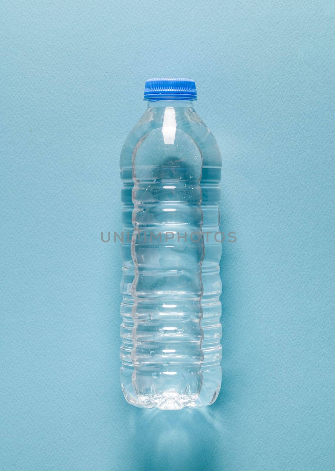 Plastic water bottle on blue isolated background