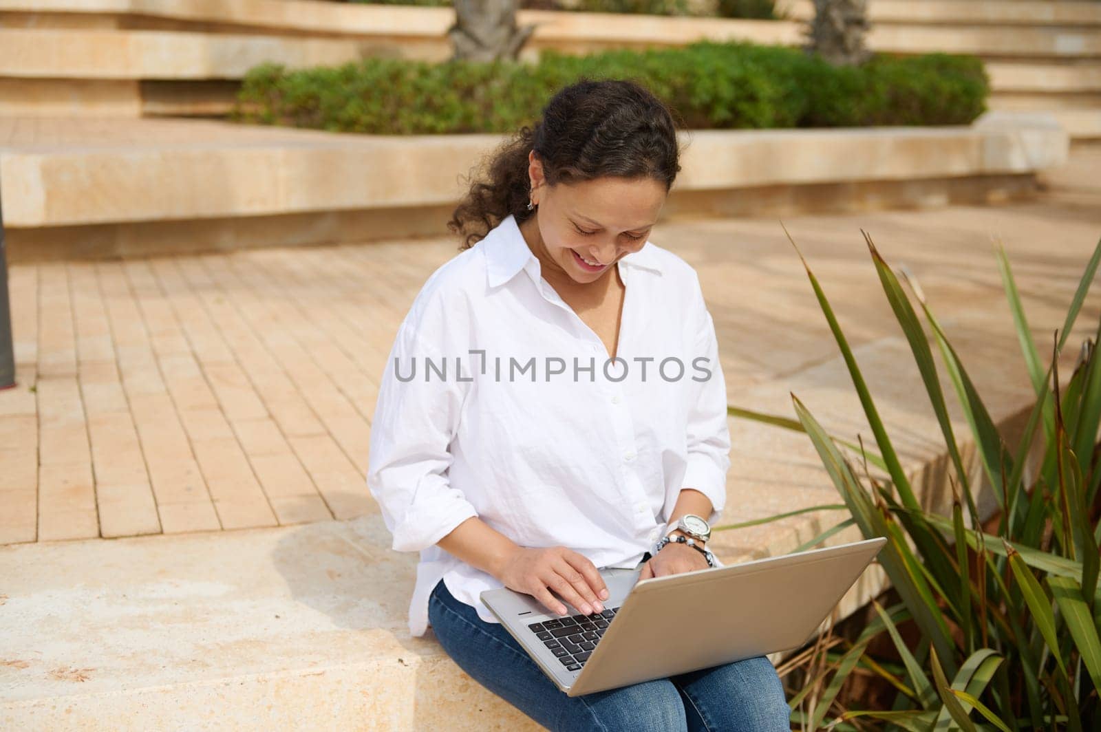 Confident female entrepreneur freelancer online working on laptop outdoor. People. Internet business. Real estate investment. E-learning. Education. Online studying. Career and recruitment concept