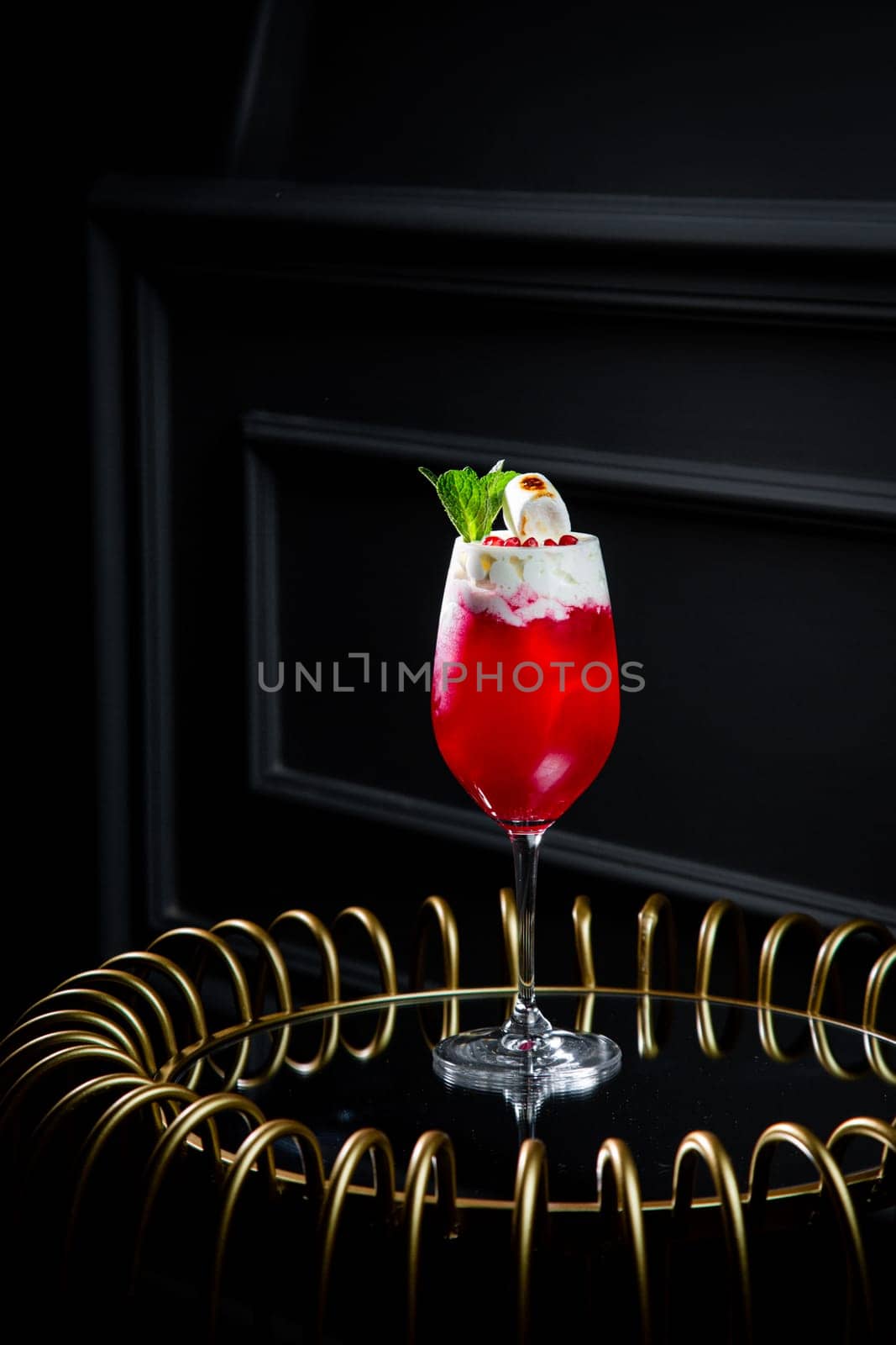 red cocktail with whipped cream instead of topping and mint leaves, side view by tewolf