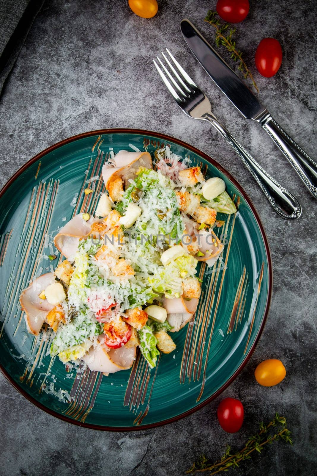 caesar salad with cheese on a blue plate. High quality photo