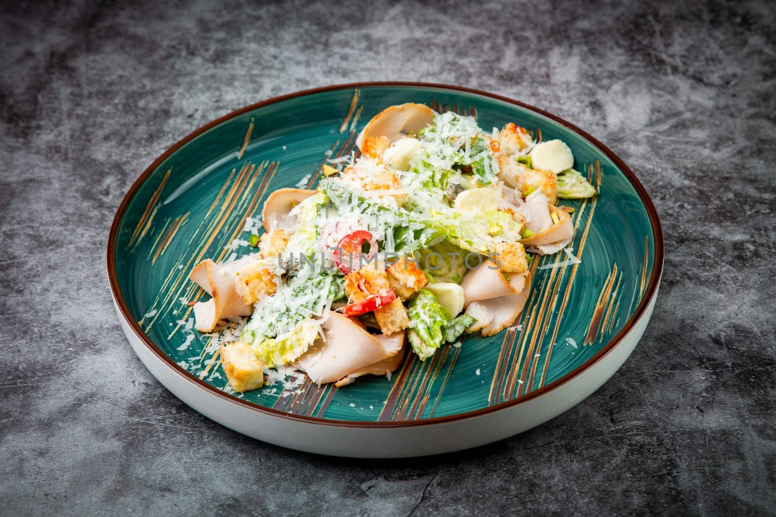 caesar salad with cheese on a blue plate. High quality photo