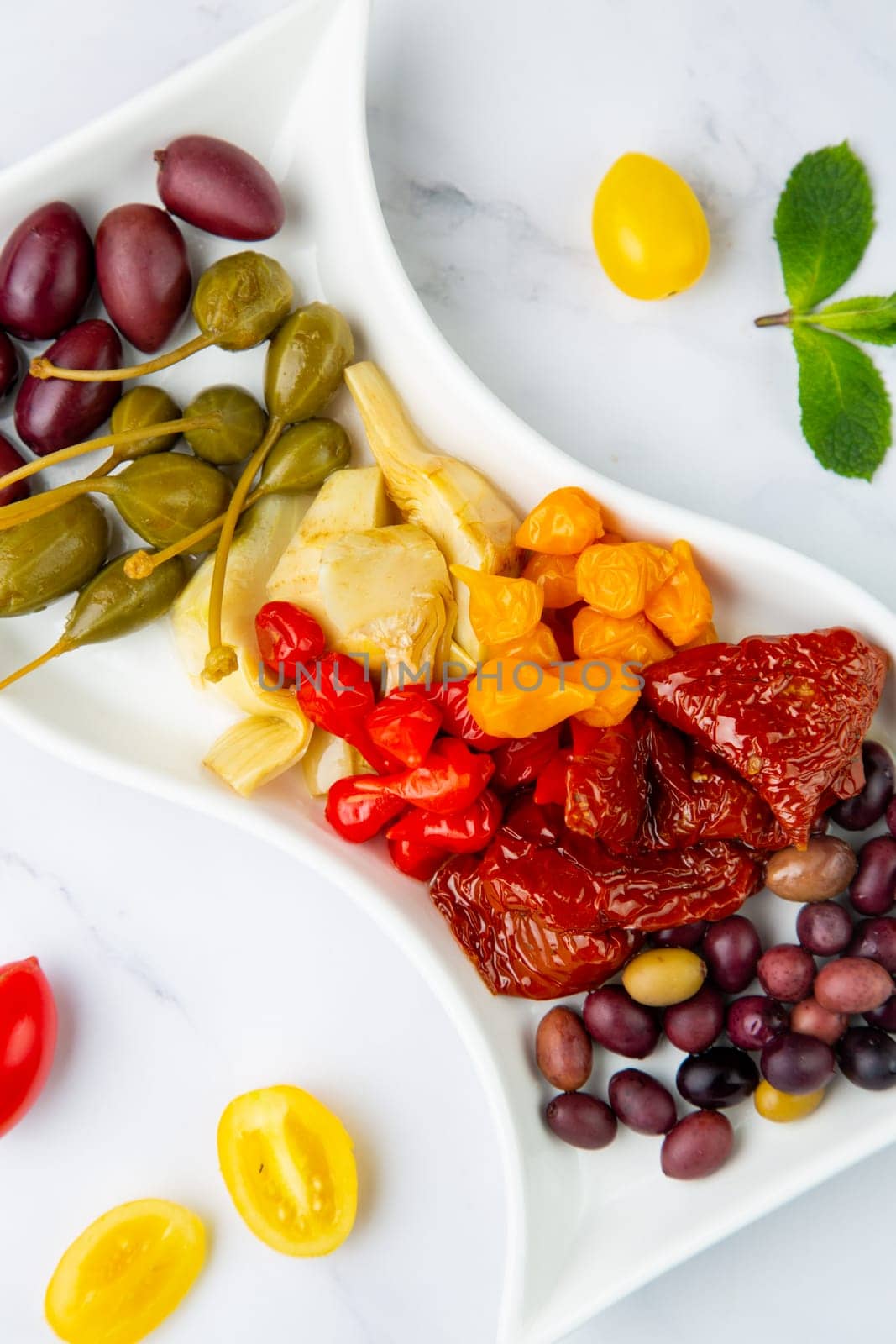 assorted nuts and dried vegetables on a light background side view by tewolf