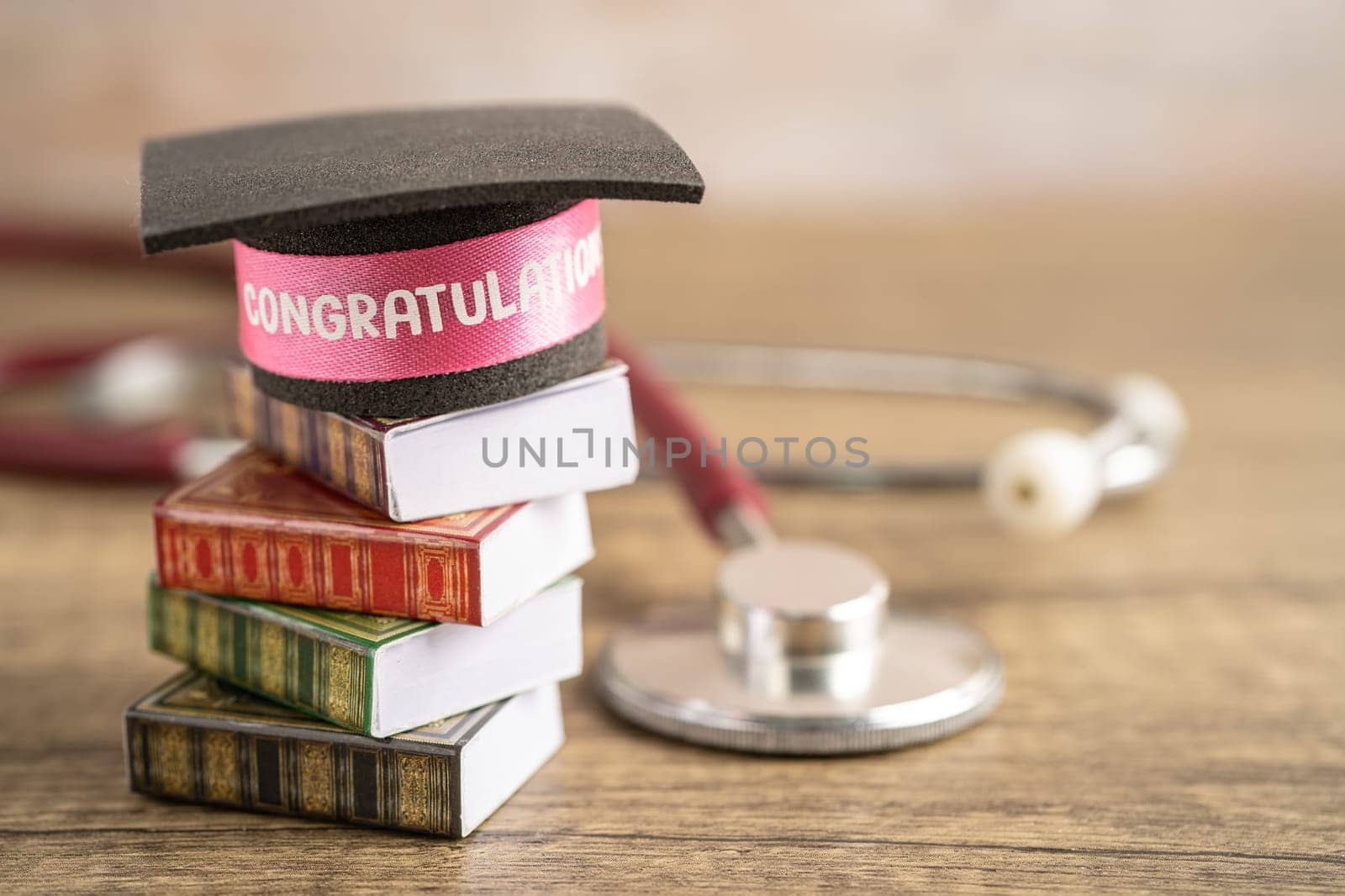 Stethoscope with graduation hat on book with copy space, learning university education concept.