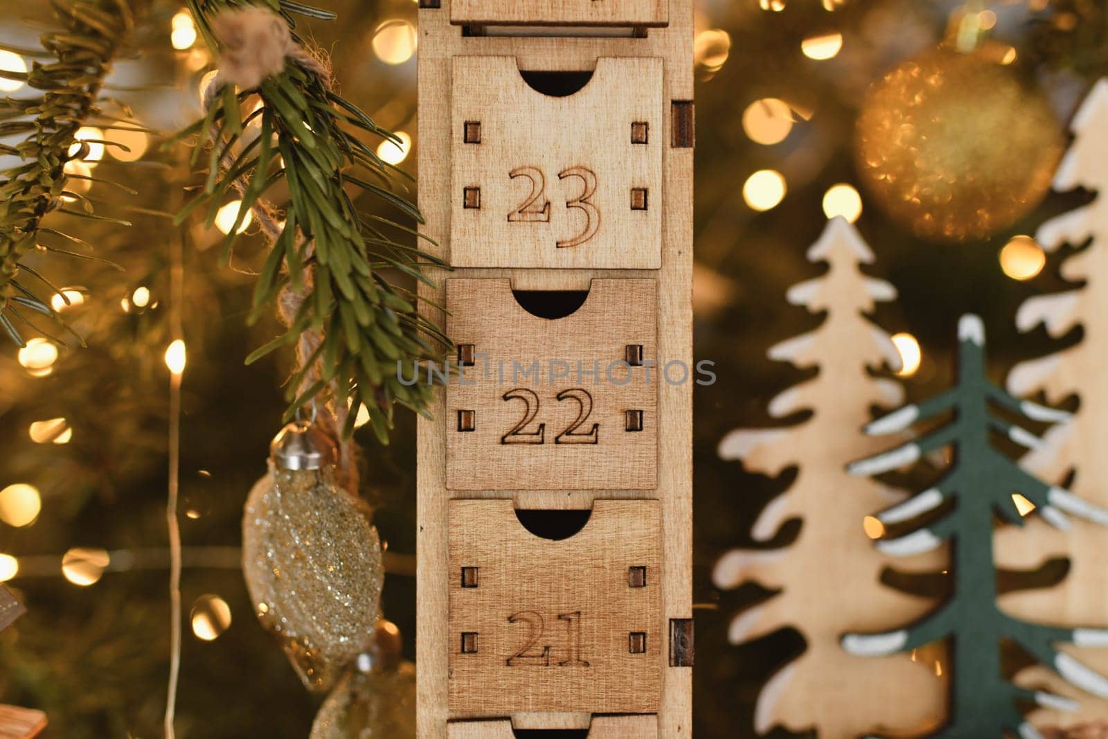 Wooden advent calendar near the Christmas tree