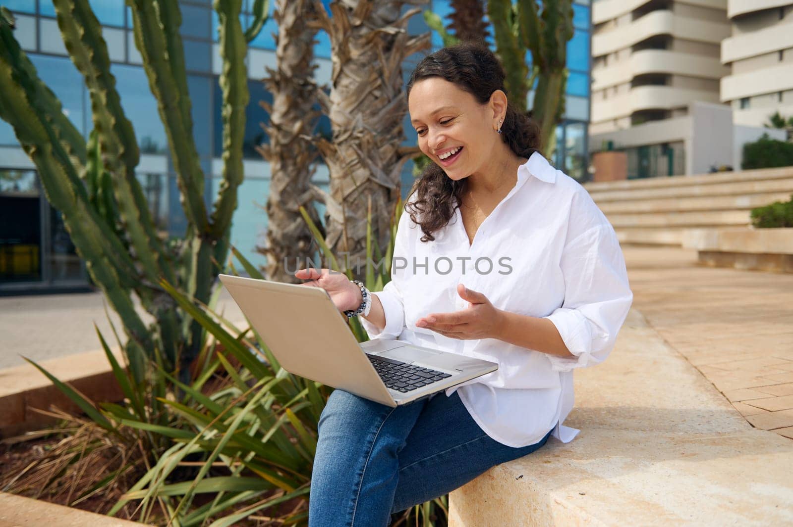 Smiling young adult woman using laptop, having an online job interview with HR department via video link. People. Online communication. Career and recruitment concept