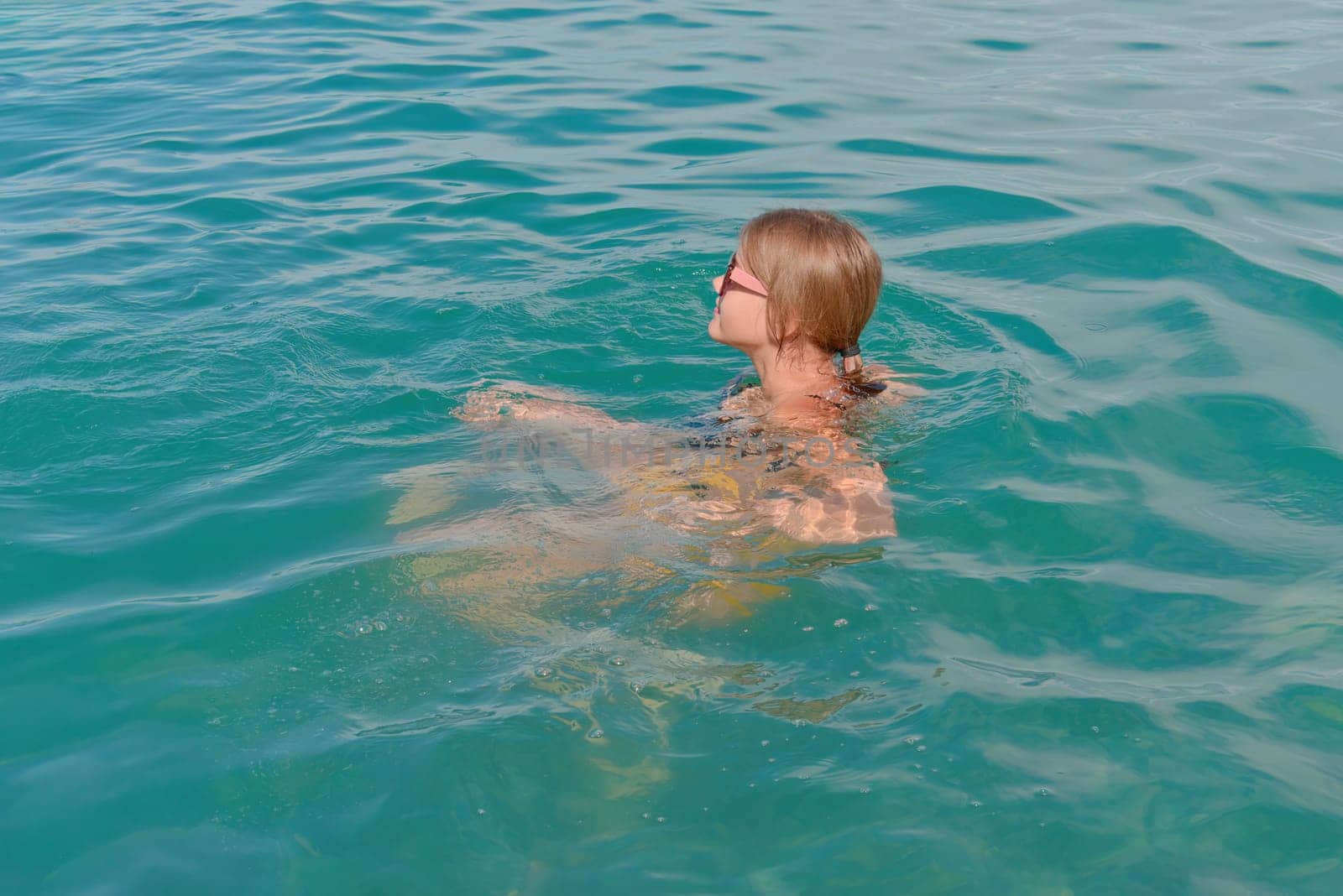 Teenage girl is in the water enjoying a sea holiday.