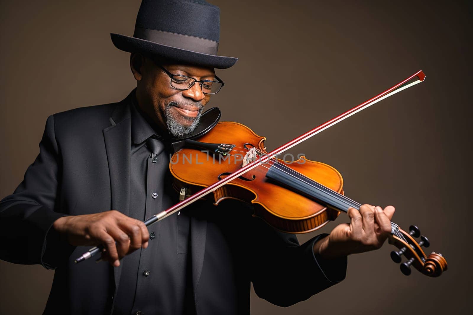 An adult African-American male playing the violin