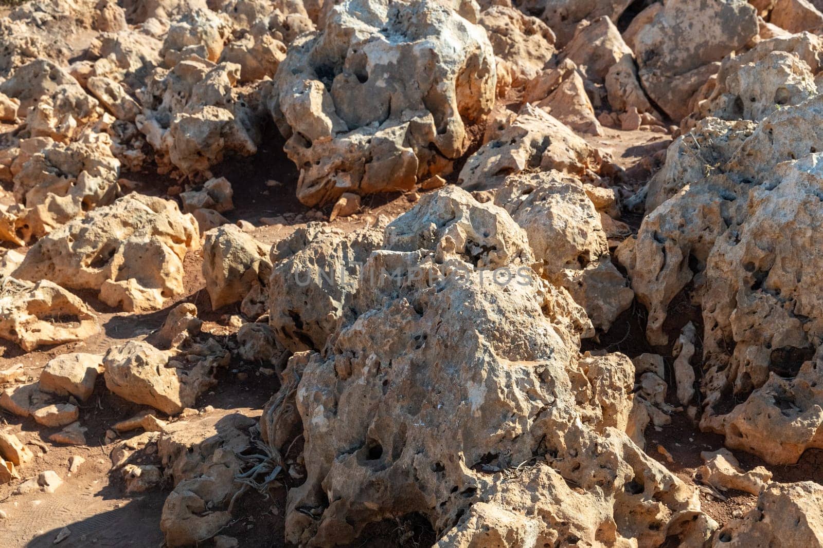 Beautiful view of textured limestone rock stones on top of a mountain on an island on a summer sunny day, close-up side view with depth of field.