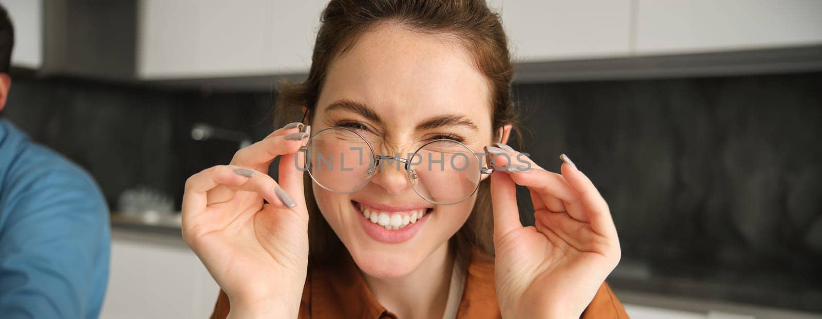 Close up portrait of attractive smiling woman with glasses, laughing and looking happy at camera.