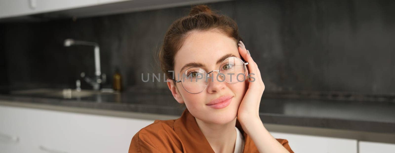 Portrait of gorgeous young woman in glasses, with happy smile, looking cute and tender, concept of modern people lifestyle.