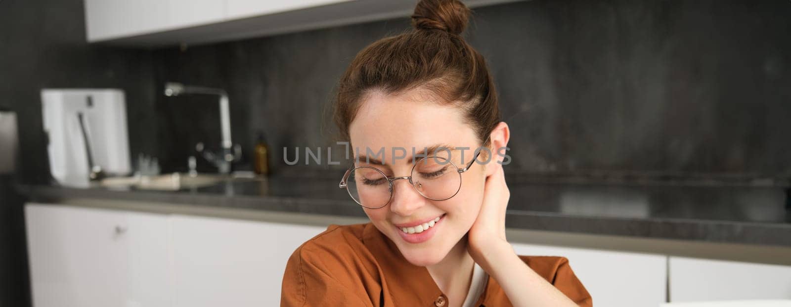 Portrait of gorgeous young woman in glasses, with happy smile, looking cute and tender, concept of modern people lifestyle by Benzoix