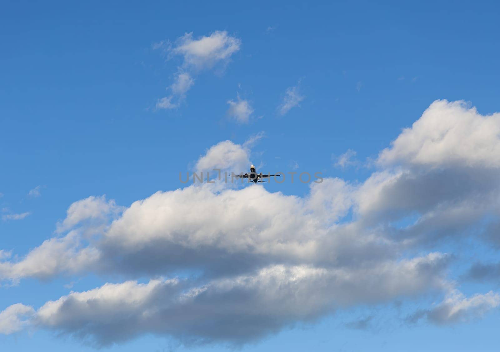 A jet airliner traveling through a clear blue sky