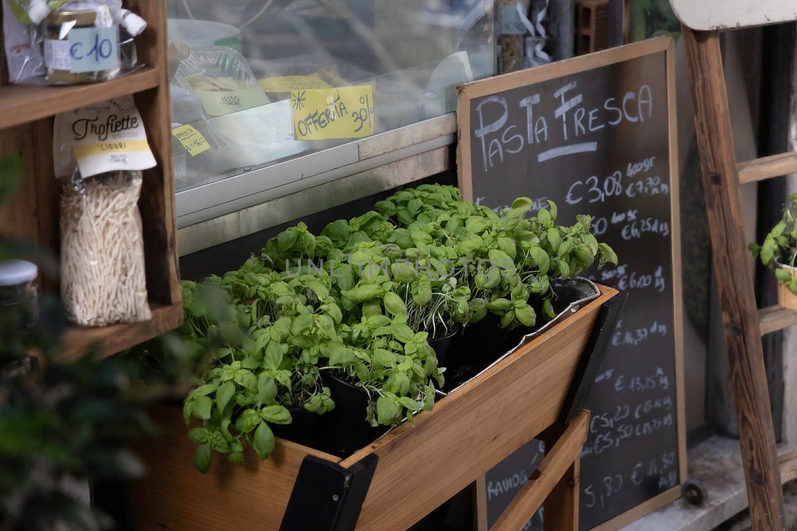 Fresh basilic and vegetables at a small market. Wellbeing and freshness.