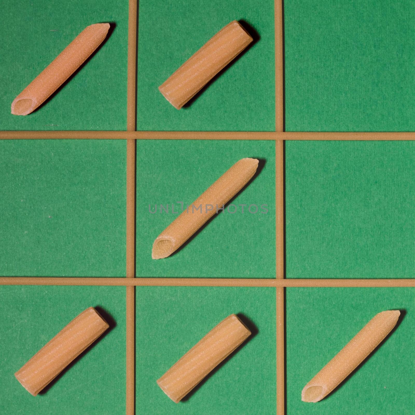 Famous game of tic-tac-toe played with penne and rigatoni