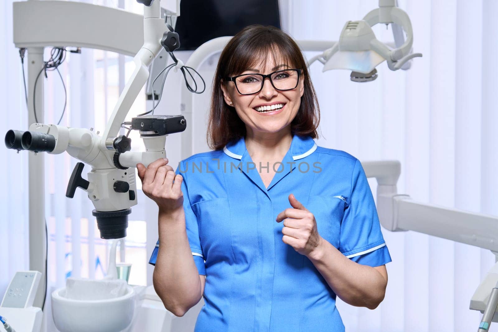 Portrait of smiling nurse looking at camera in dentistry by VH-studio