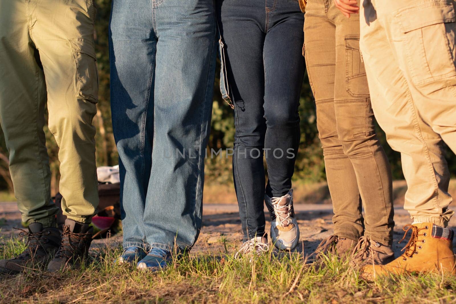 group of people prepared for a hiking, wearing sturdy shoes and thick trousers for protection from expected obstacles and ease of walking, Only legs and tracking boots are visible, High quality photo