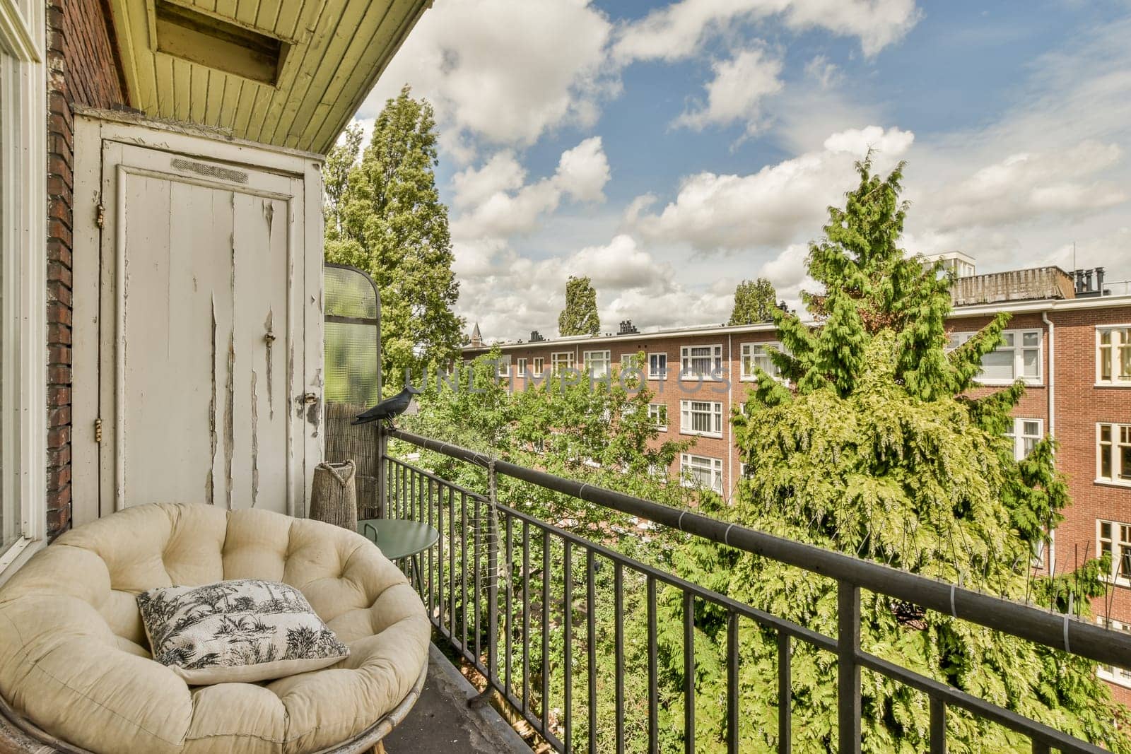 the balcony has a couch and a chair on it by casamedia