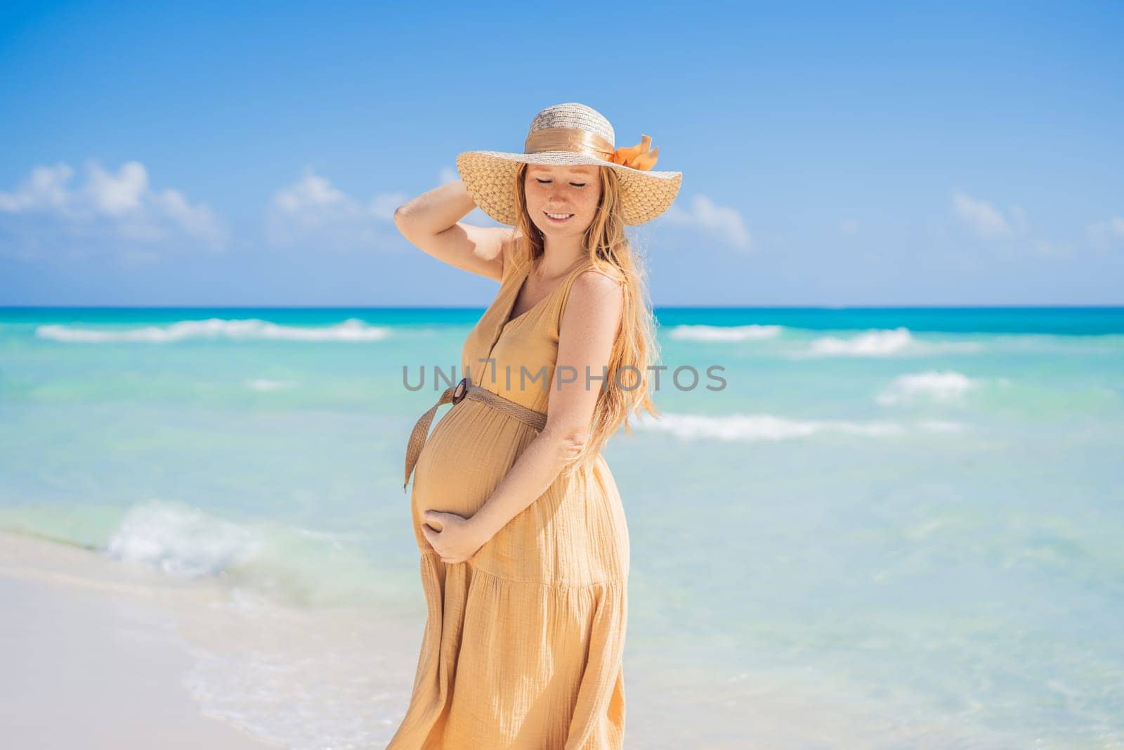 Radiant and expecting, a pregnant woman stands on a pristine snow-white tropical beach, celebrating the miracle of life against a backdrop of natural beauty by galitskaya