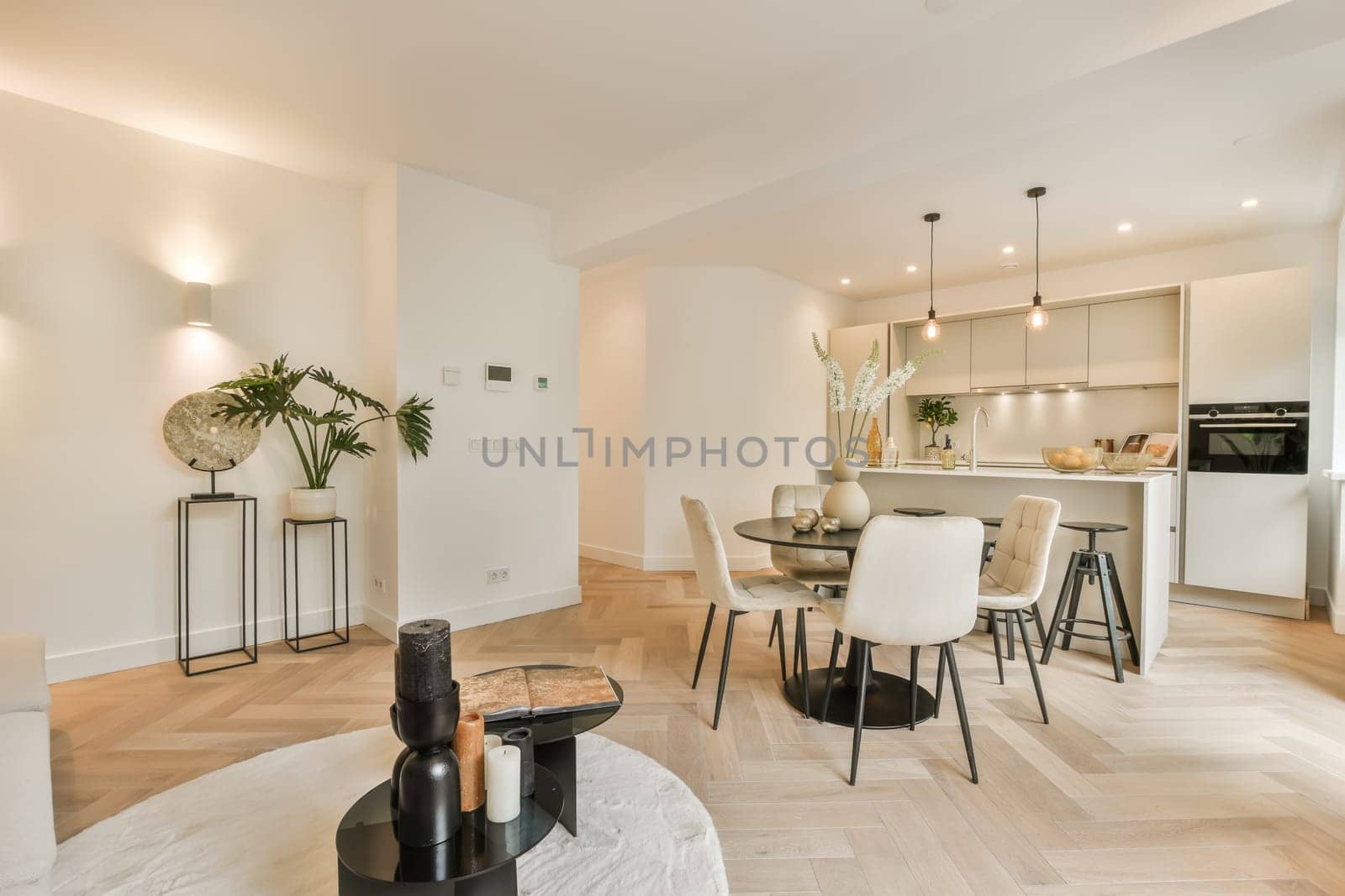 a living room with a dining room and a kitchen by casamedia