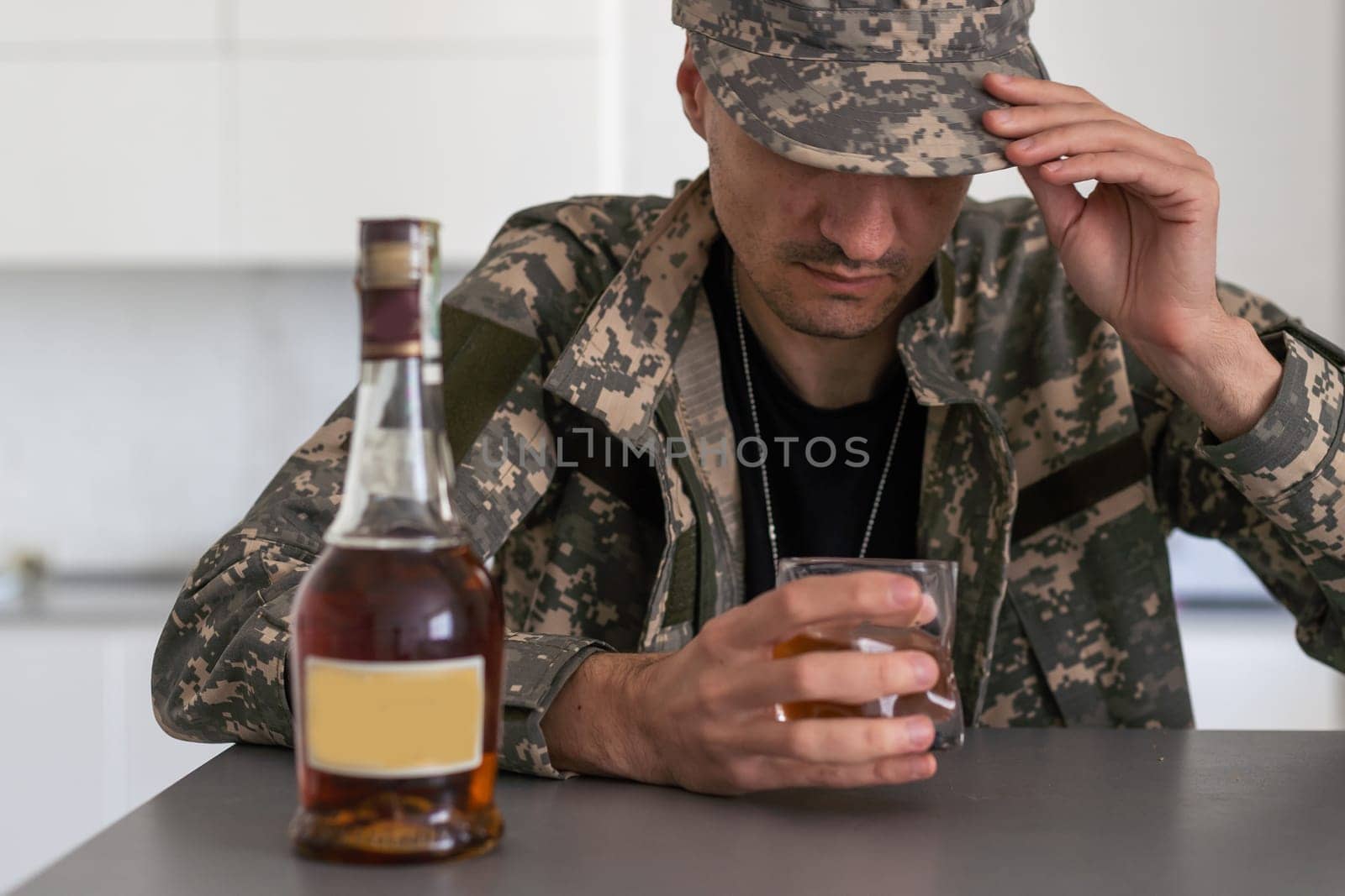 Upset young man drinker alcoholic sitting at bar counter with glass drinking whiskey alone, sad depressed addicted drunk guy having problem suffer from alcohol addiction abuse, alcoholism concept by Andelov13