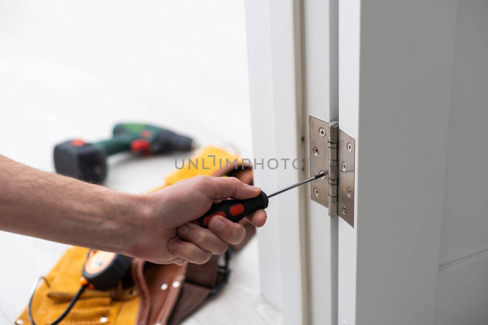 Door hinge installation. High quality photo by Andelov13