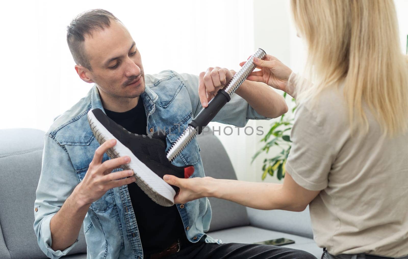 Assisted woman physiotherapist take care man with prosthetic leg and use screwdriver repair to prosthetic leg by Andelov13