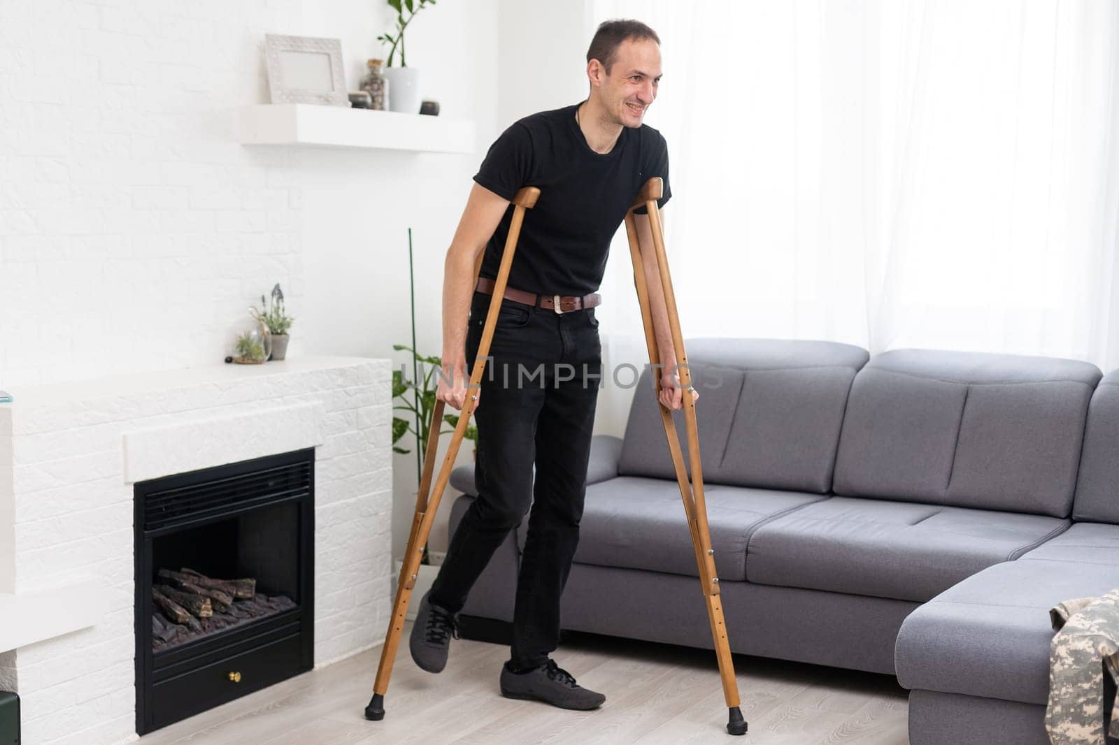 Young man with axillary crutches.