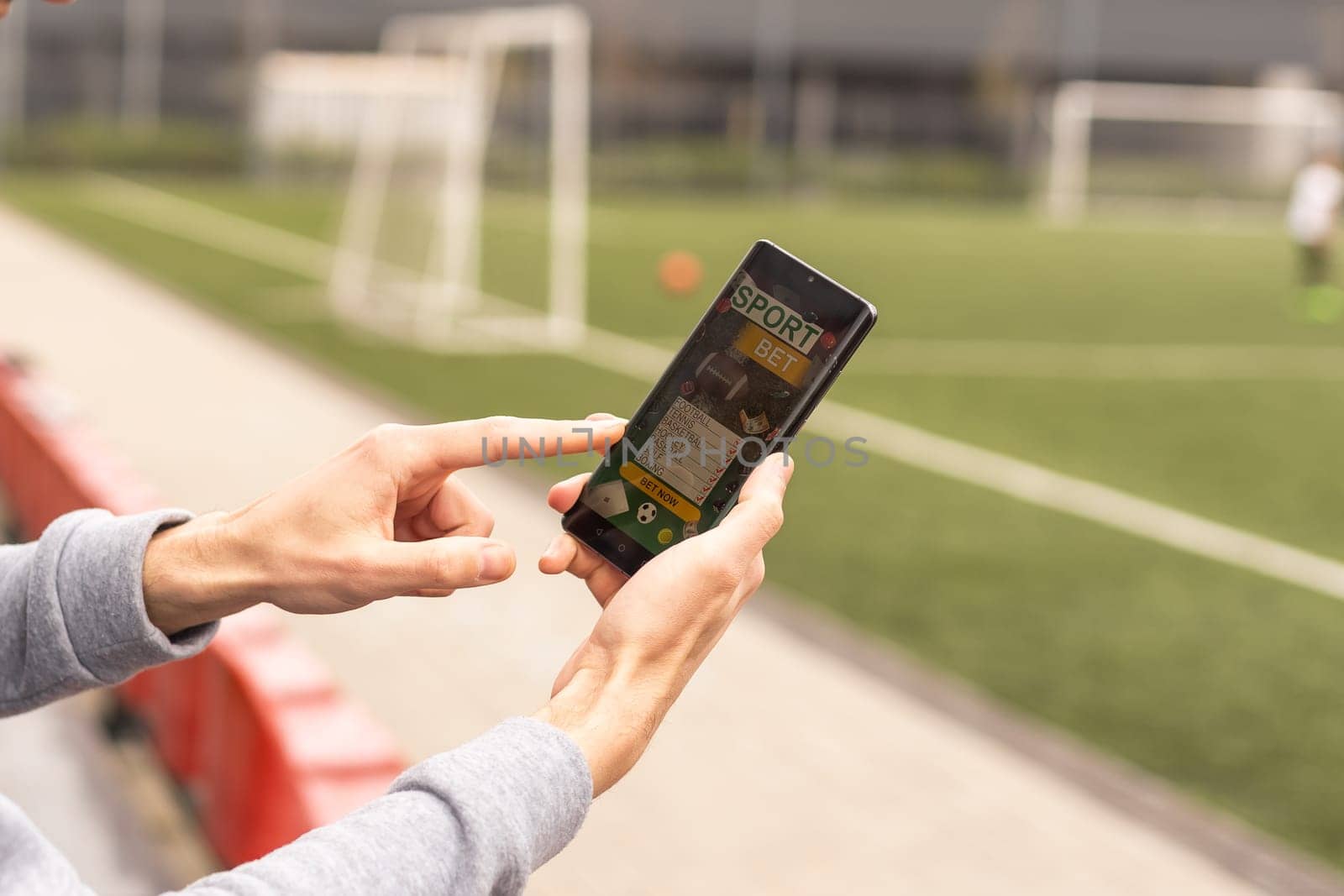 betting bet sport phone gamble over shoulder soccer live website concept