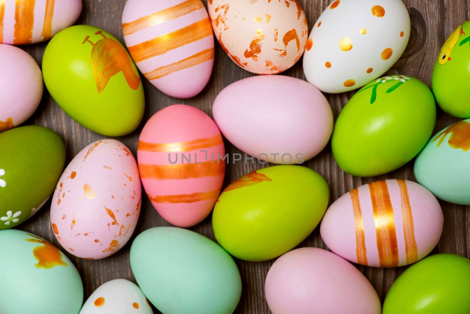 Easter eggs on wooden background. Colorful Easter eggs on a wooden background of boards.