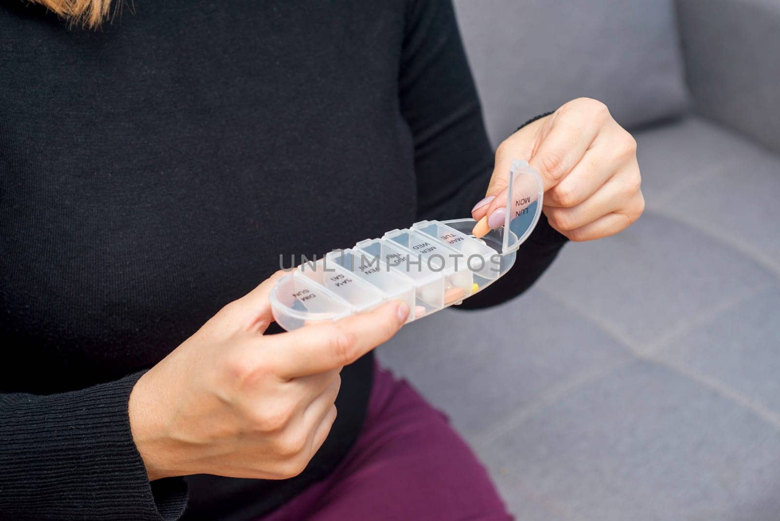 Woman taking medication from pill box. Health care, vitamins and treatment concept.