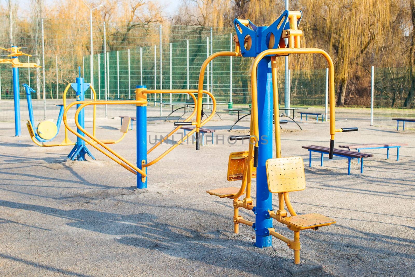 Outdoor gym in the public garden. Outdoor fitness equipment in public park. Sports simulators in the park.