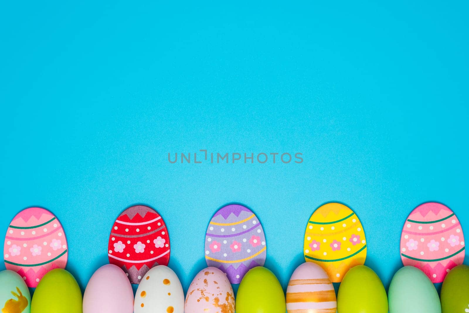 Easter Eggs. Colorful Easter eggs on blue background with copy space by andreyz