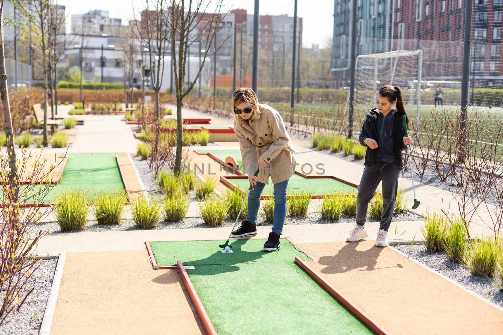 Family Time Playing Mini-Golf In The Summer.