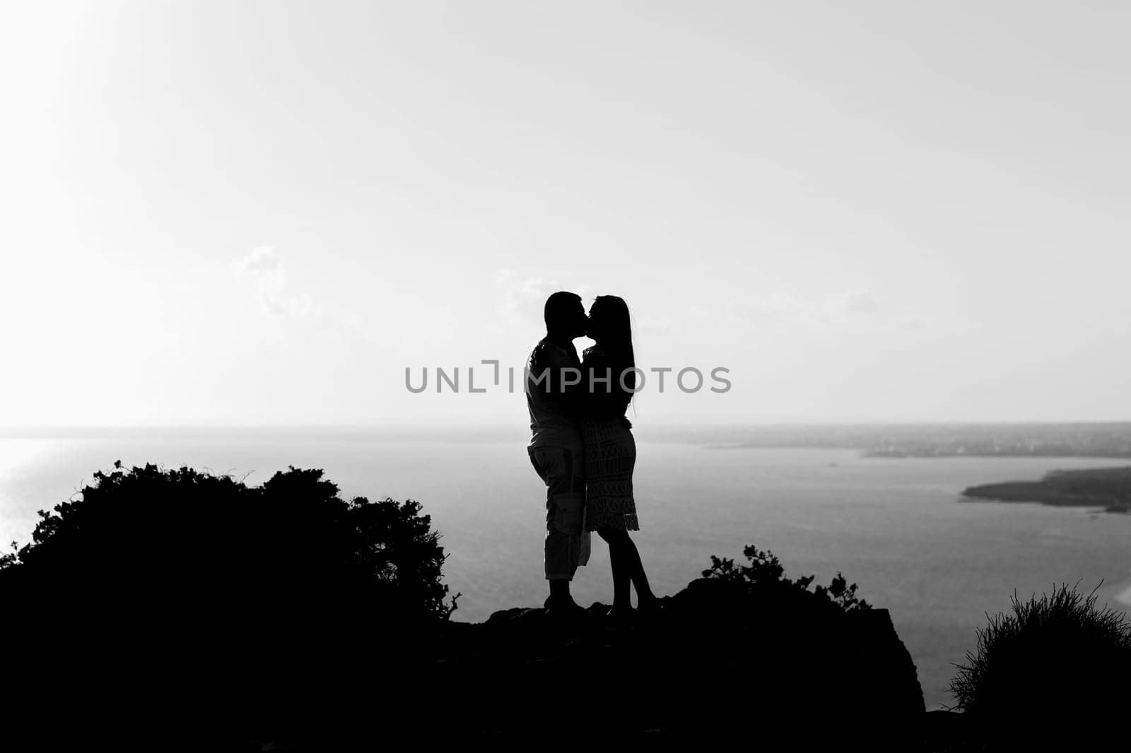 silhouette happiness and romantic scene of love couples partners on top of the mountain