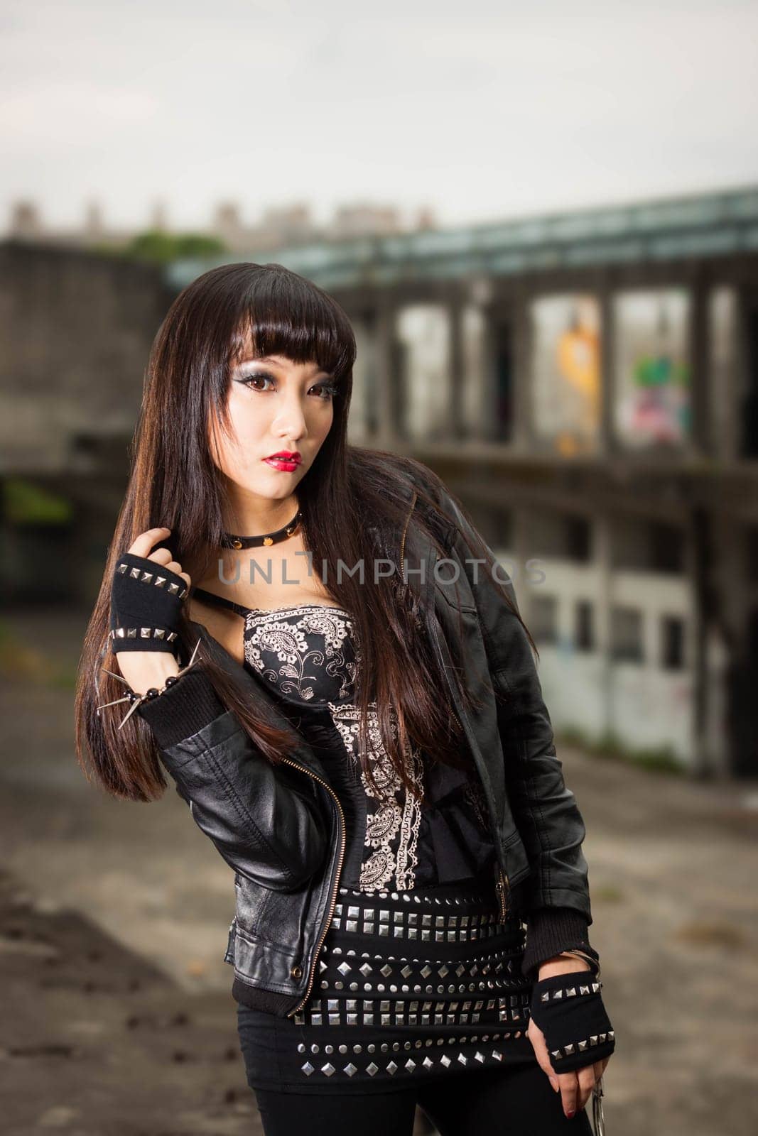 Asian woman in emo goth clothes at an abandoned building by imagesbykenny