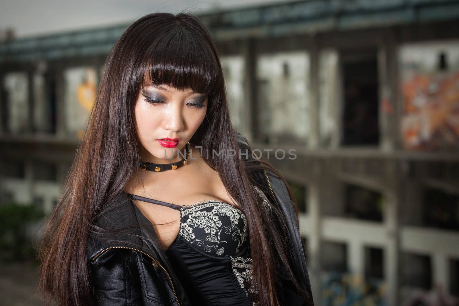 Asian woman in emo goth clothes at an abandoned building by imagesbykenny
