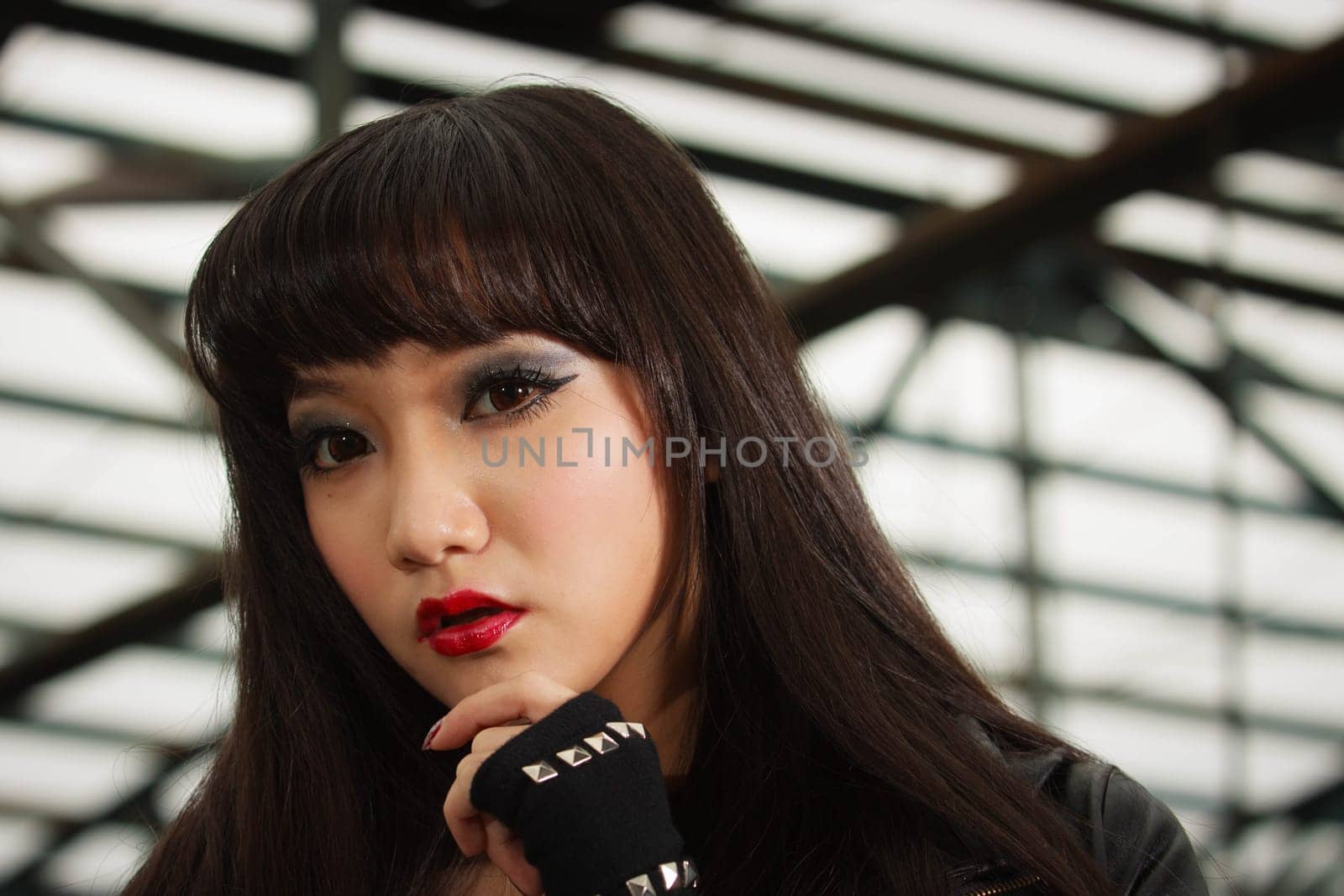 Asian American woman in emo goth clothing at an abandoned building