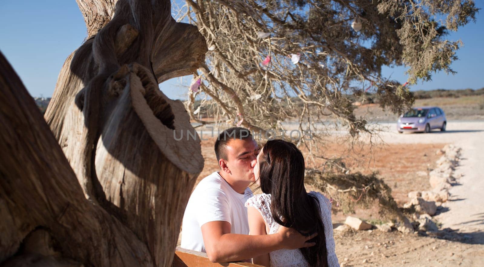 Young couple kissing under tree. couple in love
